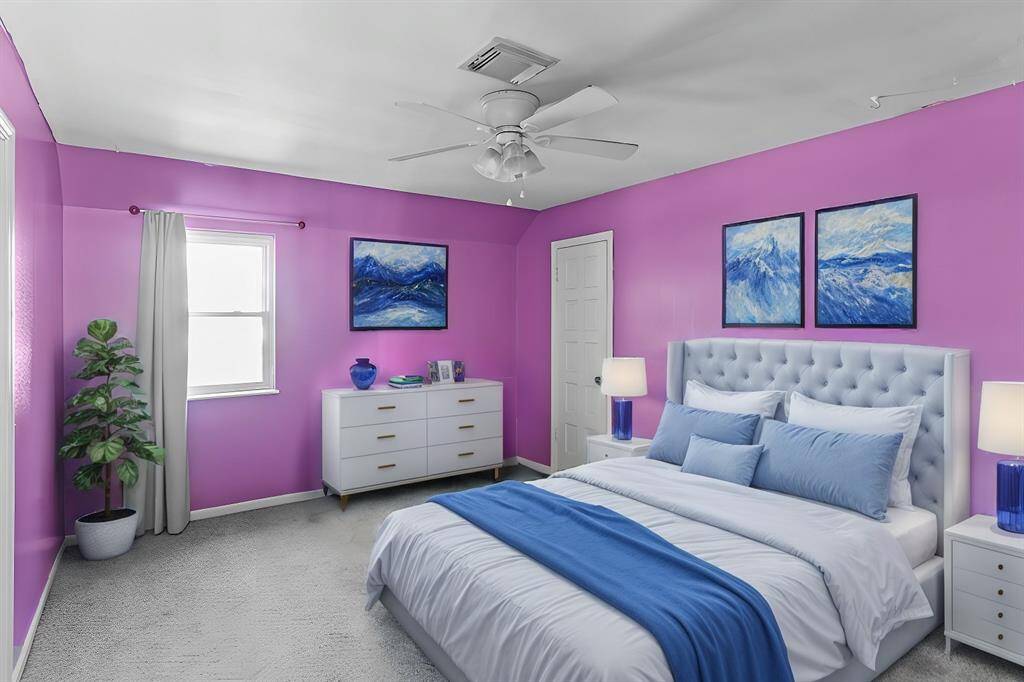 Virtually Staged: Spacious and wonderfully appointed secondary bedroom, featuring plush carpet, a large window, a ceiling fan, and a walk-in closet.