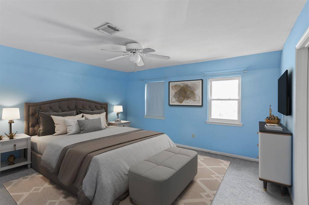 Virtually Staged: Lovely secondary bedroom featuring plush carpet, large windows, and a ceiling fan.