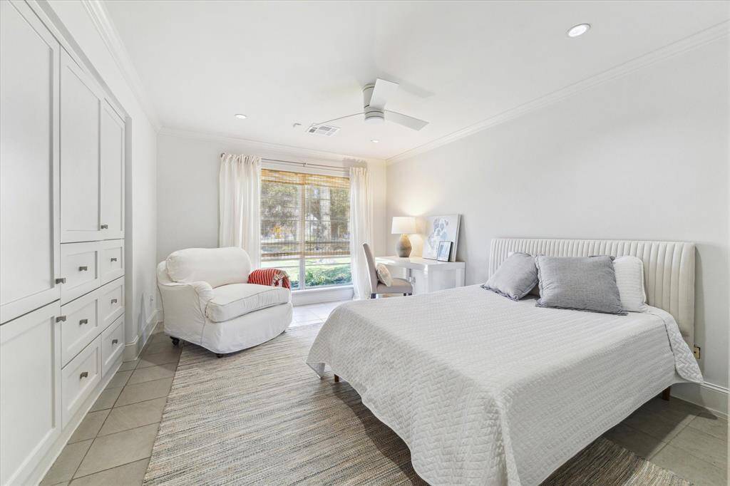 First bedroom exudes refined simplicity, featuring ample built-in storage designed for a seamless blend of minimalism and livability