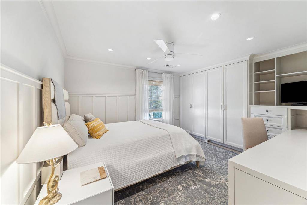 Second bedroom of the home with built-in desk.