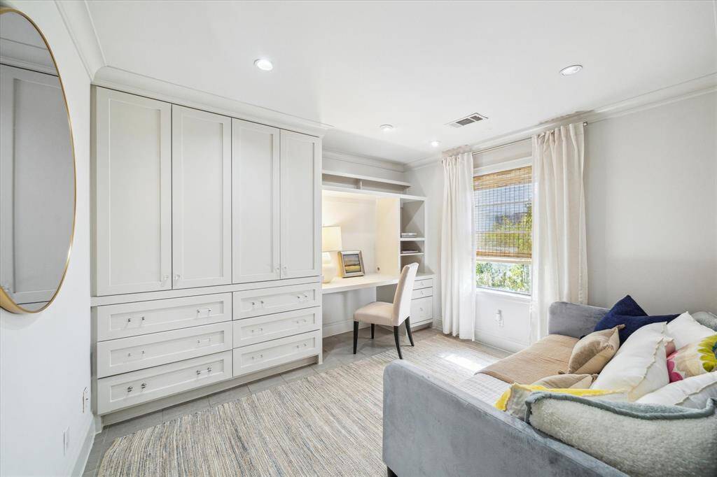 Third bedroom with a built-in desk ideal for a home office or guest space