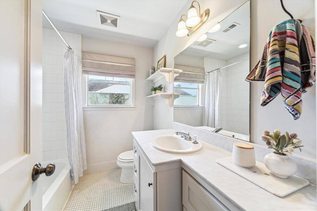 Second bathroom featuring a sleek tub
