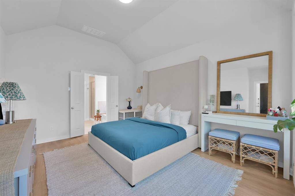 The primary bedroom features soaring ceilings, natural light and serene backyard views. Plenty of space for king-sized furniture (as in this picture) with room to spare. **Furnished rental option available. Ask for details.**