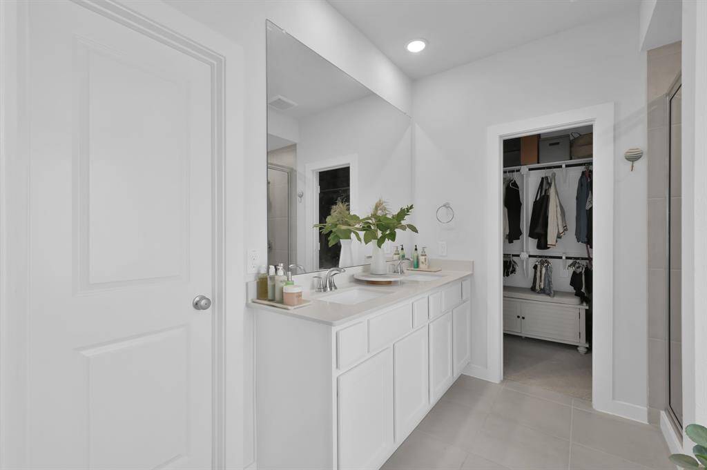 The primary bathroom features double sinks, garden tub with separate shower, and a walk-in closet