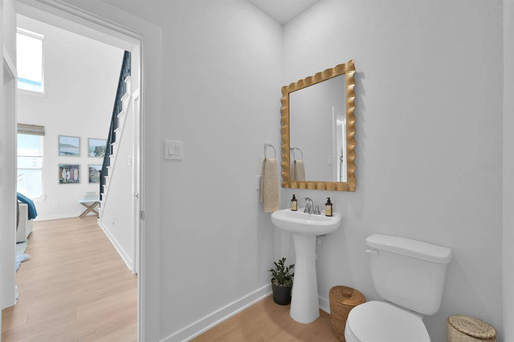 The half bath is located off the family room and across from the home office/optional 4th bedroom