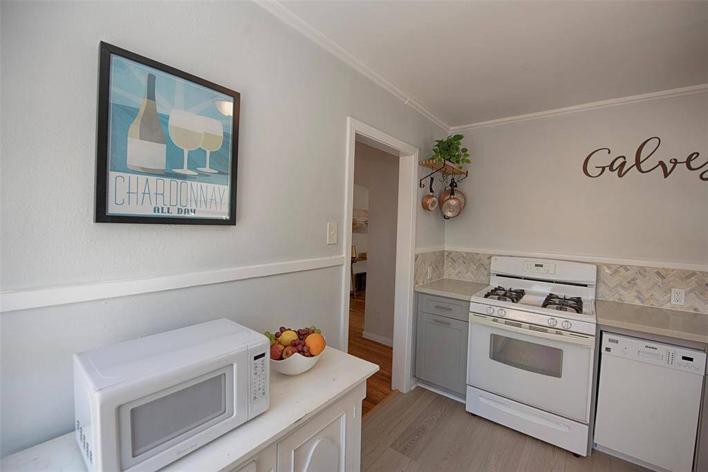 Kitchen buffet cabinet is home to the microwave, providing space for additional storage.
