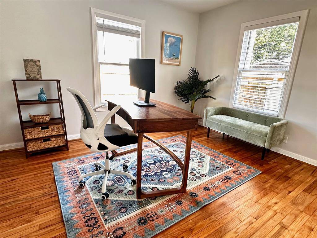 Secondary bedroom at the back of the home is currently set up as a home office. It's an ideal work space if not needed for a bedroom, though a full or queen size bed will easily fit in the space.