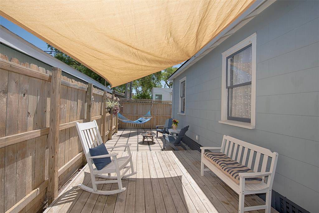 Imagine curling up with a book or setting up the BBQ grill and entertaining your friends on this shady decked back patio.