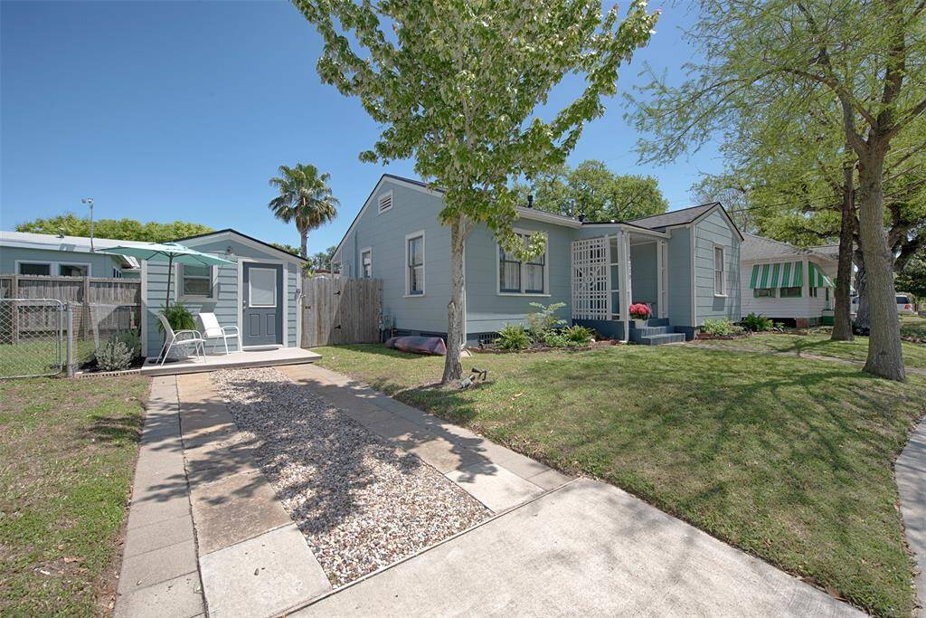Streetside view of the home and the front porch entry to the studio addition. Imagine using it as your office, a guest space, a game room, or an additional rental unit.