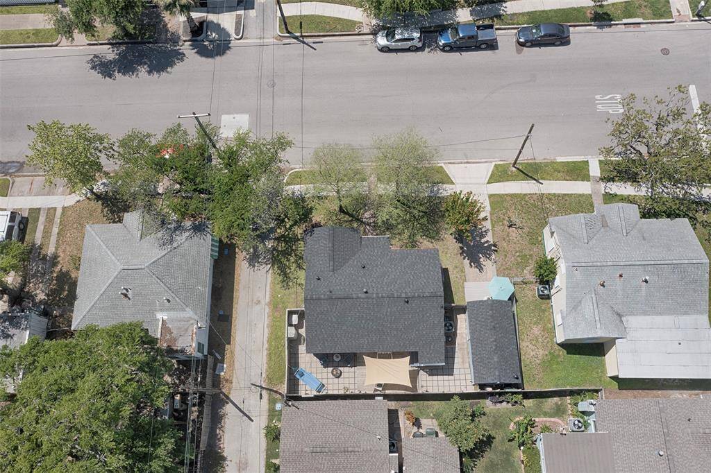 An aerial view of the back patio area. Note the two side gates on each side of the house that lead directly to the alley and to the front drive of the home.