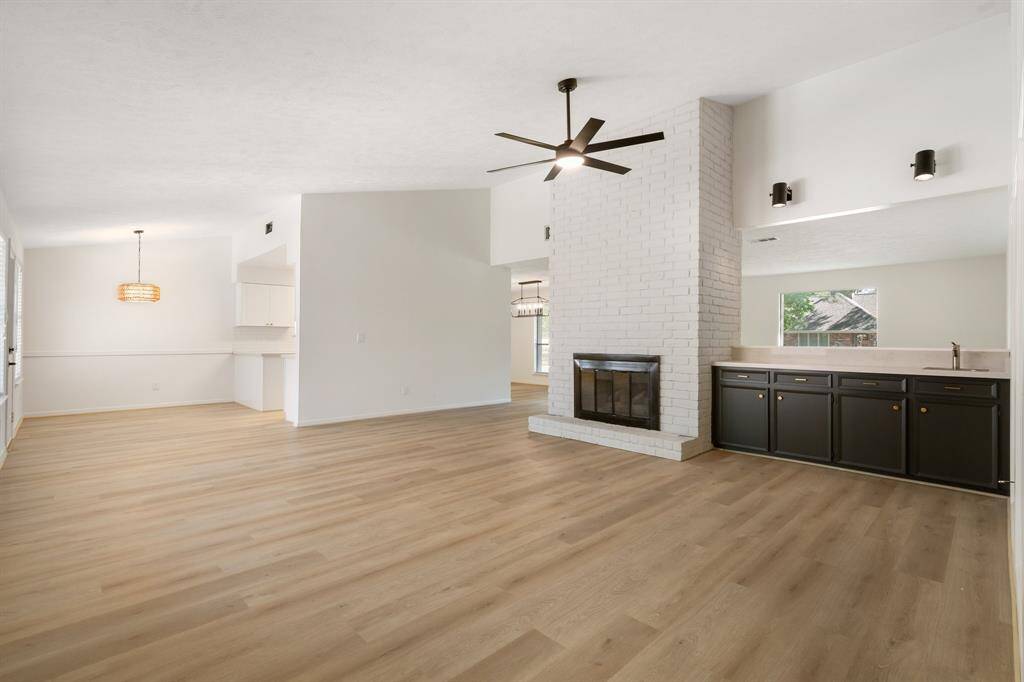 Spacious family room with tall ceilings and a wet bar, perfect for entertaining.
