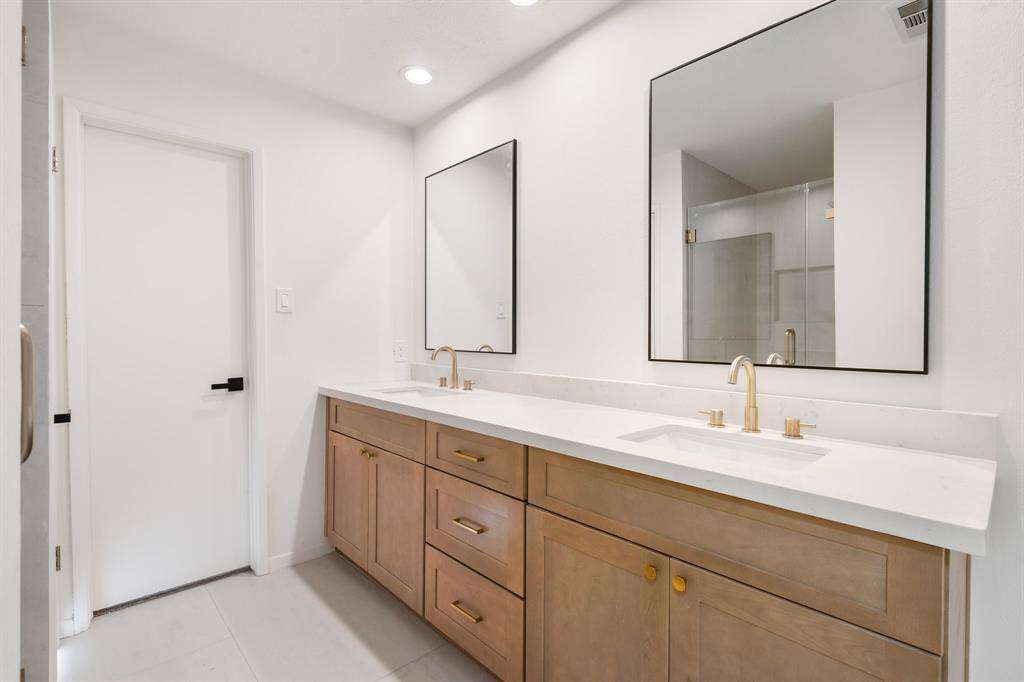 Stunningly remodeled master bathroom including his & hers closets.