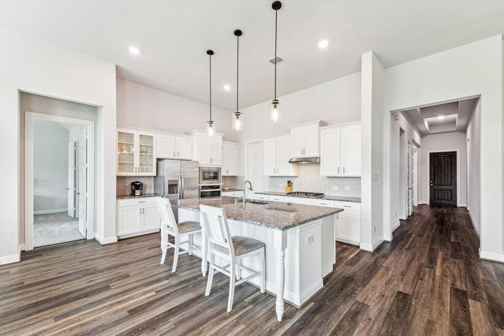 Chef's kitchen featuring all stainless steel appliances - refrigerator stays!