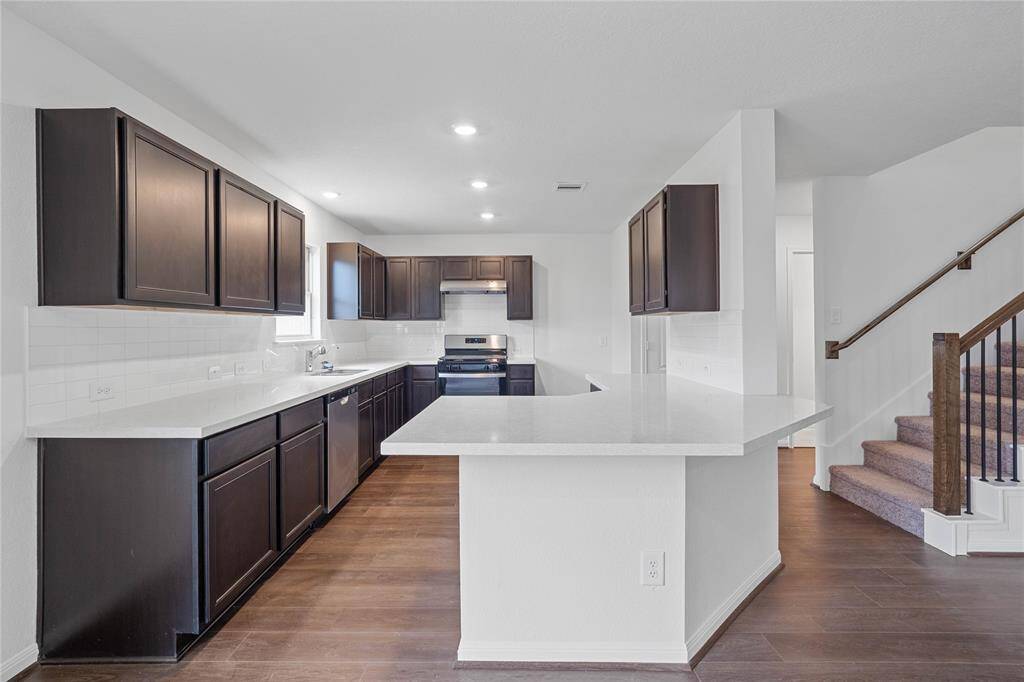 Additional view of this spacious kitchen and staircase leading to the second floor!