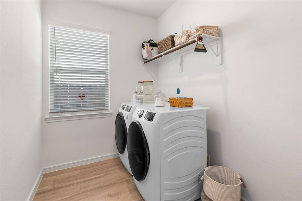 Spacious laundry room with room for shelving or an extra refrigerator.