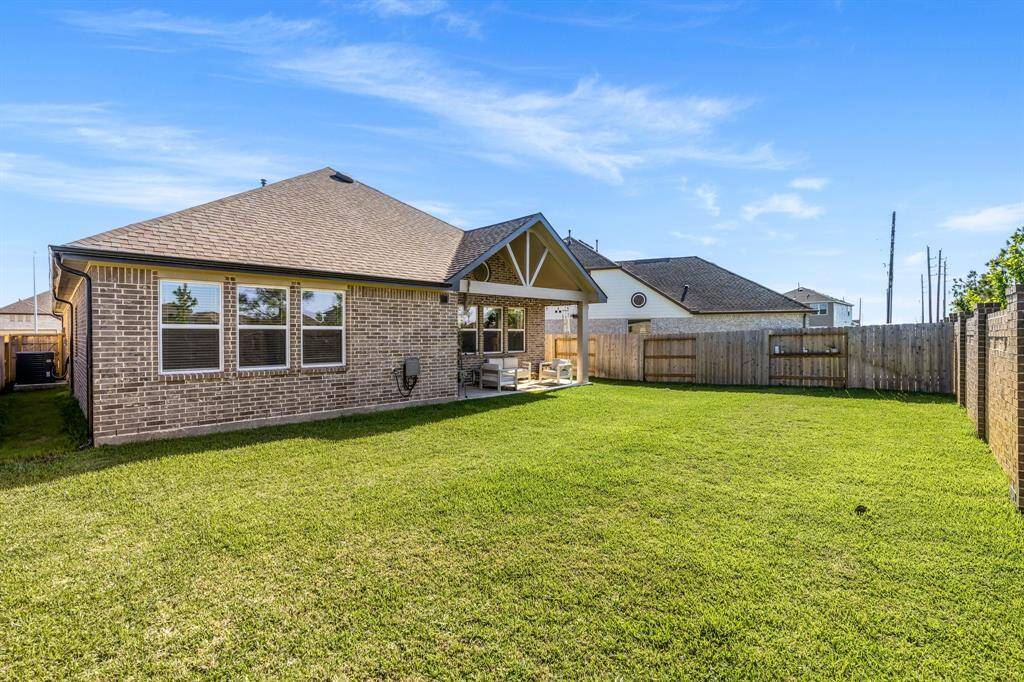Spacious backyard with a large patio, perfect for entertaining or your future pool.