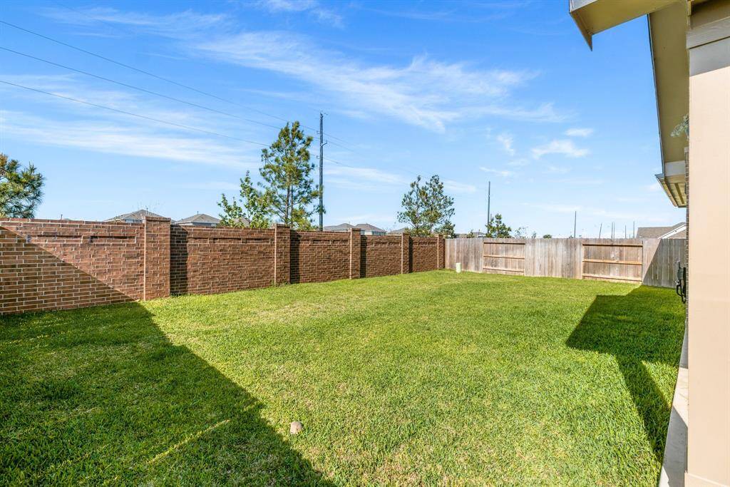 Brick fence along back of the home with no back yard neighbors.