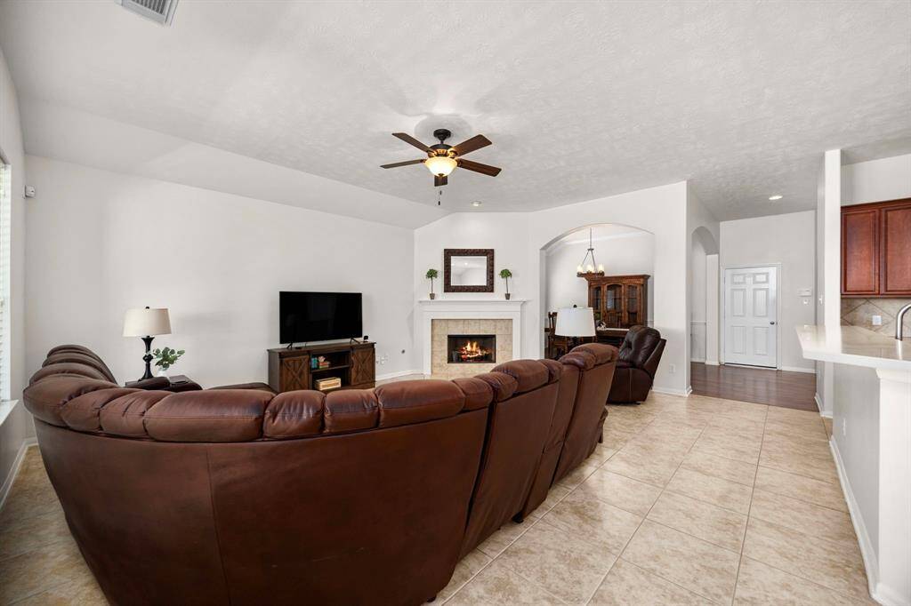 Another perspective of the family room with views through the covered patio and into the backyard.