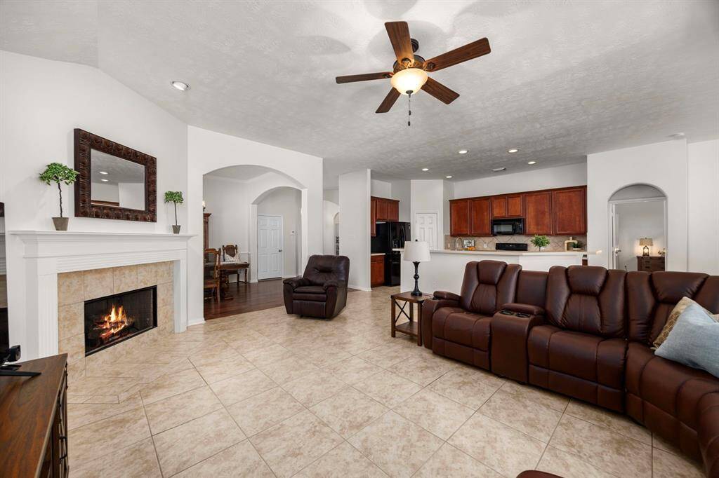 A large living area with a gas fireplace is a cozy spot to relax or to entertain