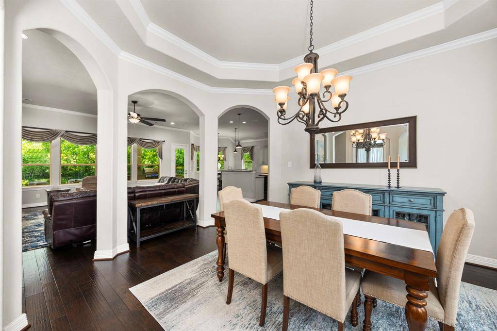 Another view of the dining room with three beautiful arches into the family room. A perfect place for hosting special dinners and memorable celebrations.