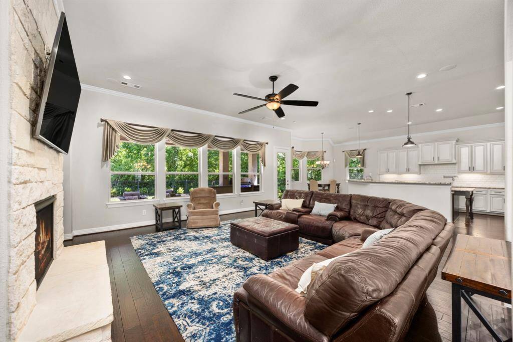 Upon entering the grand family room, you are immediately drawn to the wall of windows that overlooks the backyard patio and gorgeous wildlife preserve. Or you might notice the open living concept and attractive gourmet kitchen in the back. The family room is grand, both in size and style. The ceilings are high with crown molding and recessed lighting.