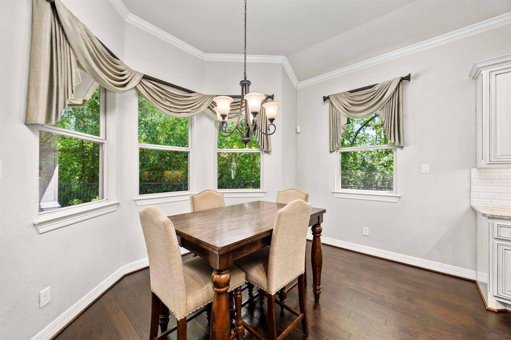 The breakfast area is spacious enough for a large dining table and chairs. The windows fill the space with beautiful natural light offering great views of the surrounding nature preserve.