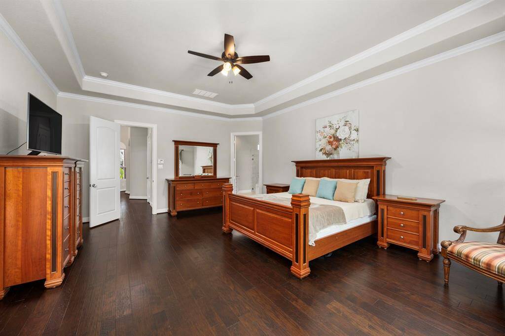 The primary retreat unites form and function with a raised tray ceiling that adds both drama and volume. The room is very spacious with tons of wall area to accomodate many pieces of large furniture.