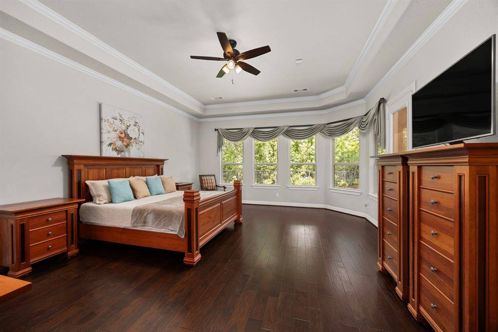The bedroom not only is spacious but offers a second wall of windows overlookingthe wooded nature reserve, with plenty of space left for seating. The back door on the right leads out to the back patio.