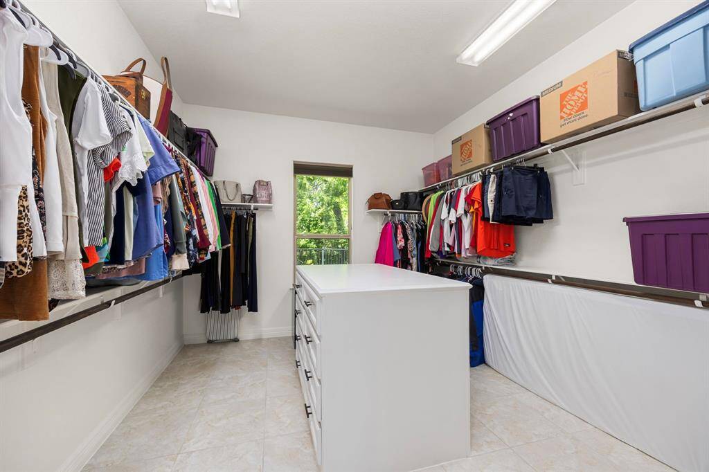 HER walk-in closet even has a built-in dresser and a nature view!