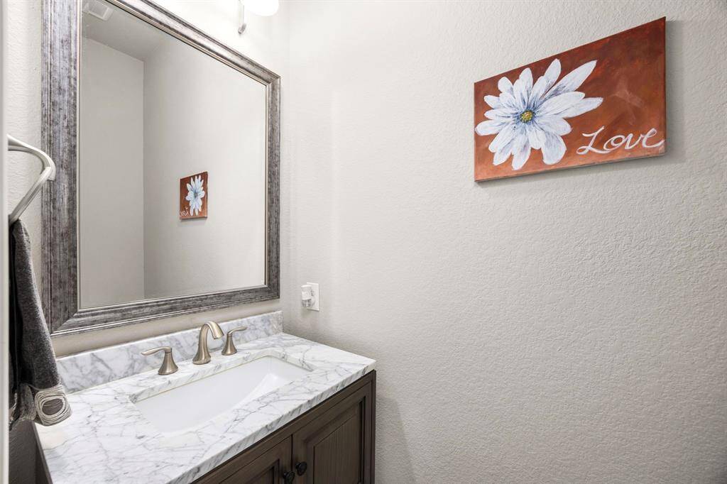 This powder bath is located off the main foyer and is convenient to the main living areas of this home.