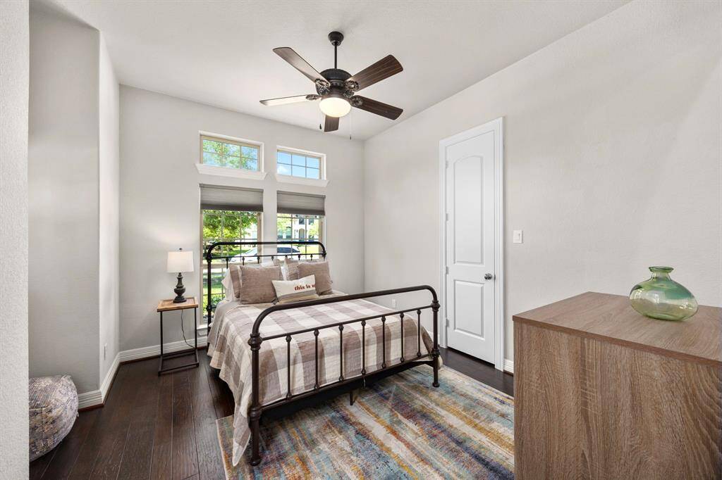 Secondary Bedroom #3 is light and bright with windows looking out to the front and a side window looking out to the courtyard.