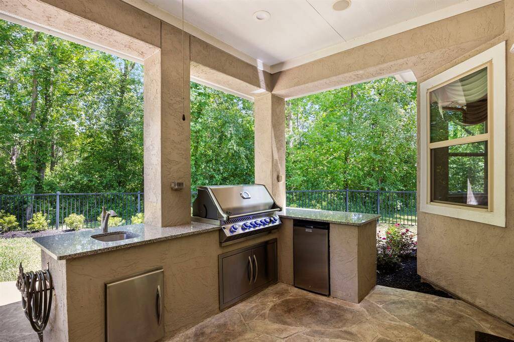 Outdoor cooking in the woods?  This is the way to do it with your grill, refrigerator and sink on a covered patio!