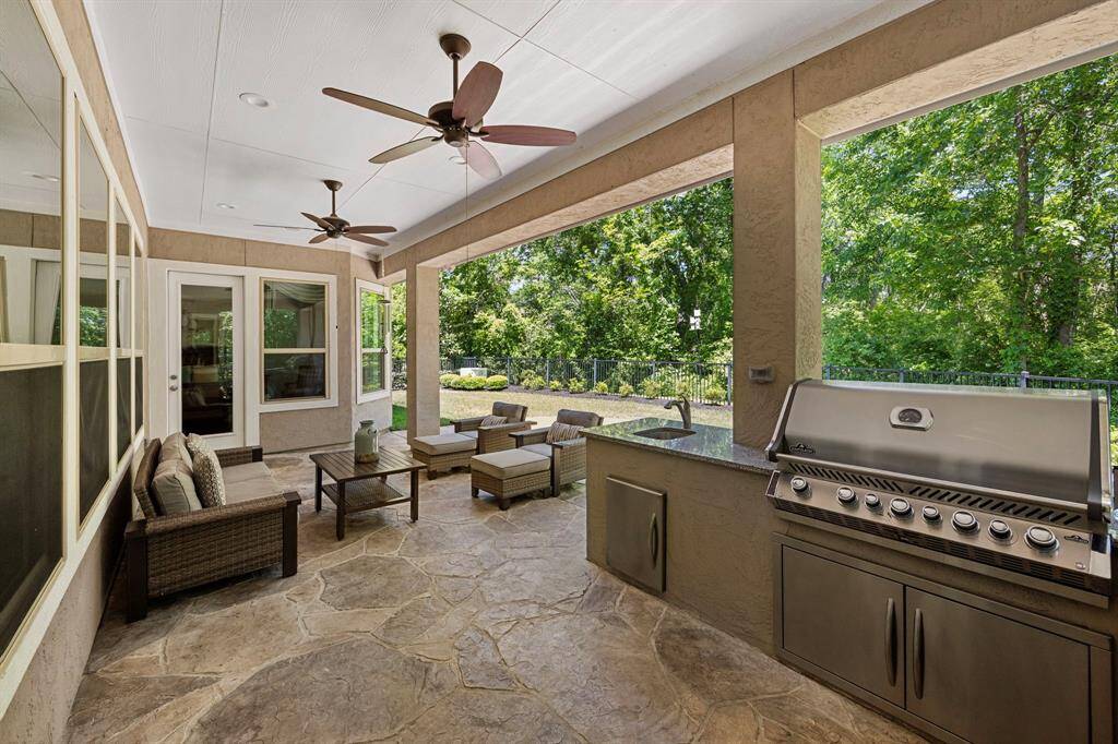 This luxurious extended patio overlooks the gorgeous nature preserve.  The ceiling fans help wirh the heat while you sip a cool beerage and enjoy the wildlife!