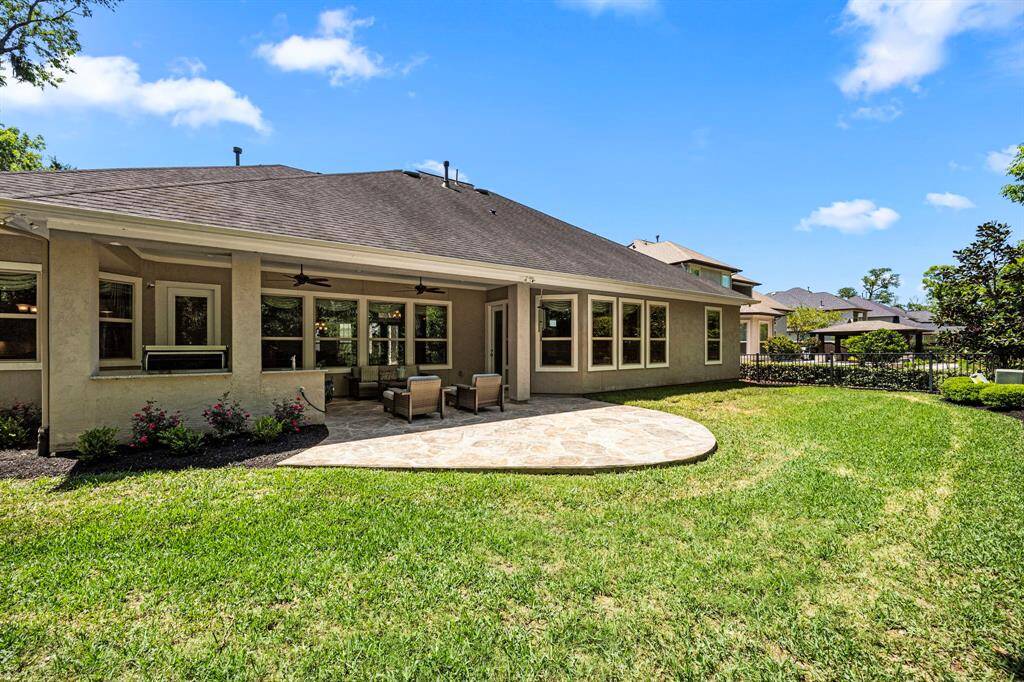 The back elevation shows the size of the extended patio and the numerous windows giving a serene view from many areas of the home.