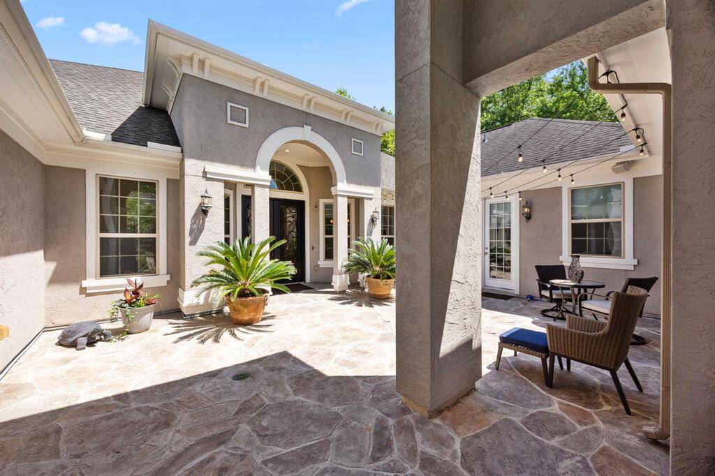 The beautiful, central courtyard creates the perfect, private hideaway and entryway to this gorgeous home. Extra attention to the design of this courtyard was carefully planned and implemented, including but not limited to the roof gutter-guards and over-sized downspouts, supplemental French drainage system, and sloped stamped concrete overlay which directs water away from the foundation of the interior structure.