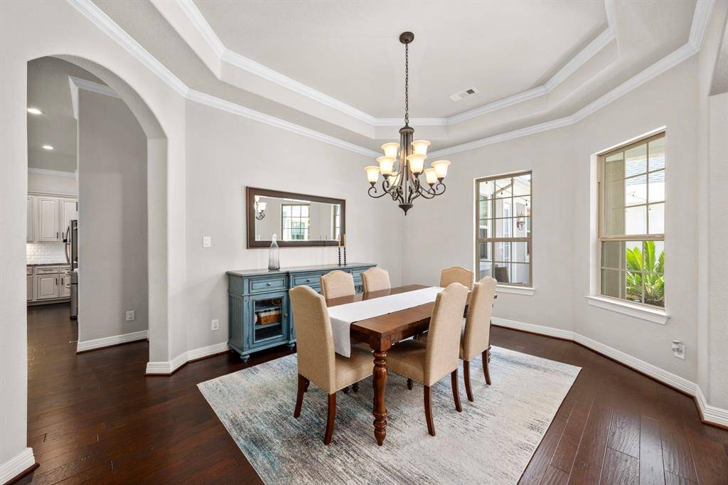 A closer look in the Formal Dining Room shows the front windows adding warm natural light, but added privacy since they are overlooking the enclosed courtyard. The area is grand in size with plenty of room for a large table, buffet or serving console.