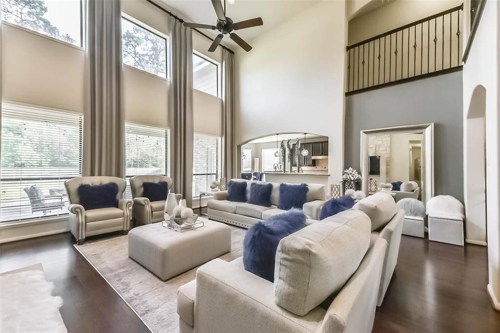 Abundant natural light pours in through large windows, illuminating the open living and kitchen area