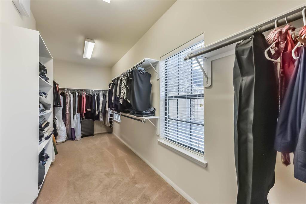 Spacious walk-in closet with plenty of room for all your wardrobe essential.