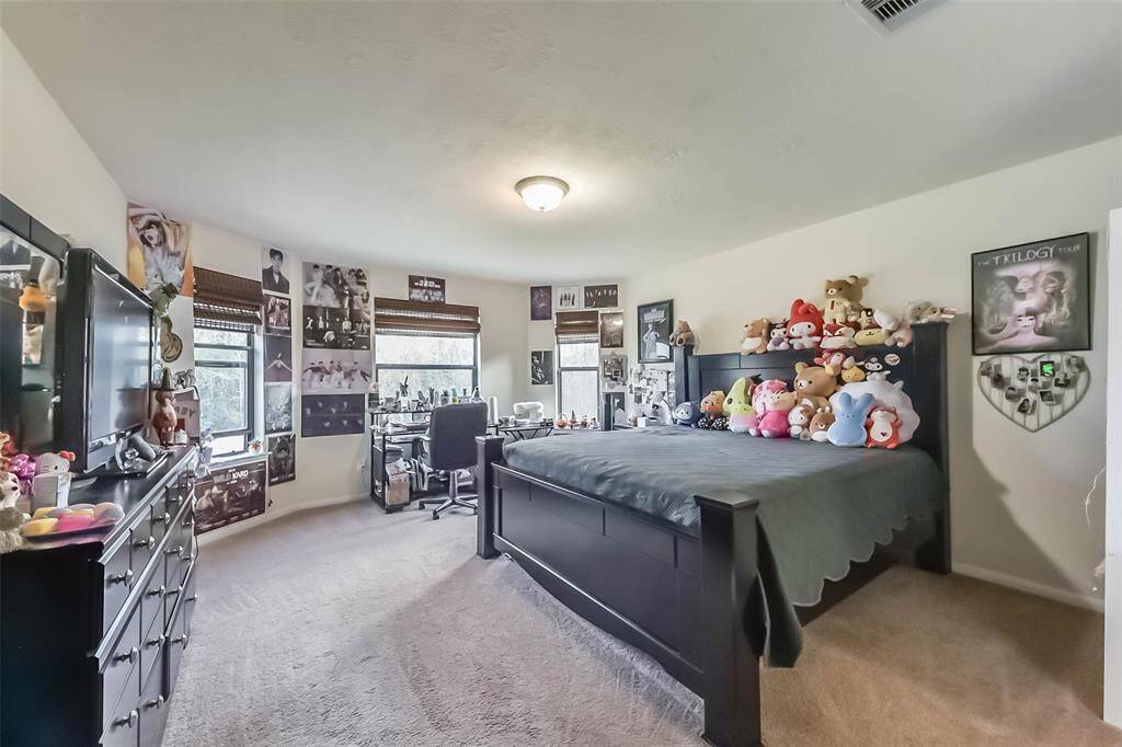 Generous upstairs bedroom with a private bathroom and walk-in closet