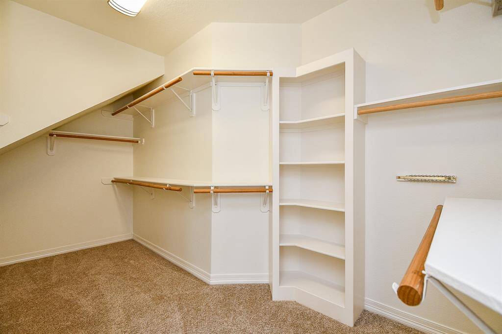 Spacious walk-in closet in the primary bedroom with ample shelving and hanging space.
