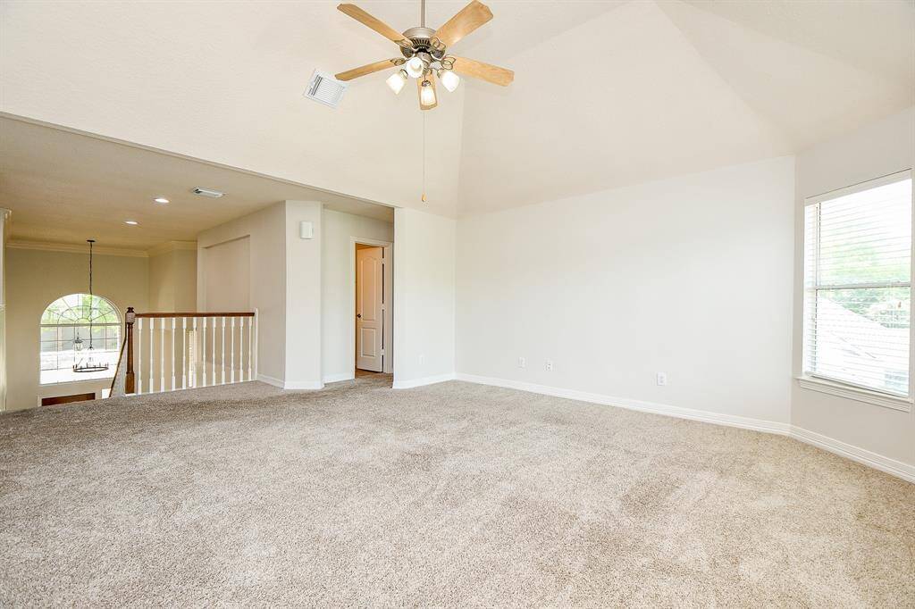 Spacious and versatile game room with natural light, perfect for entertainment or relaxation.
