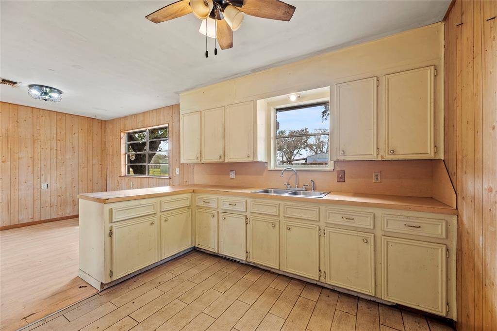 The open kitchen is beautiful, inviting, and functional, with tons of cabinet space.