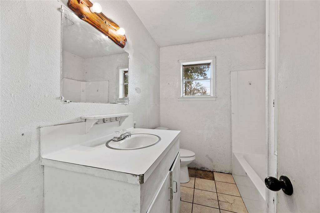 The bathroom is ready for a refresh—just a little TLC to make it shine!
