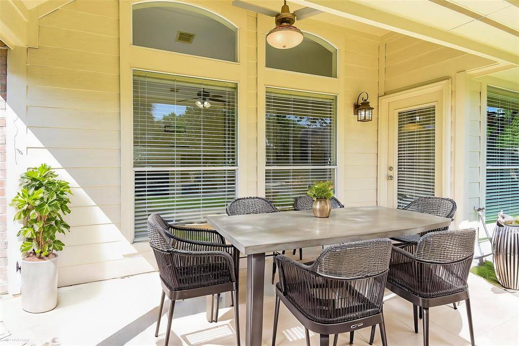Step outside to a spacious covered patio, perfect for outdoor dining, relaxing with a book, or entertaining guests. Virtually staged photo