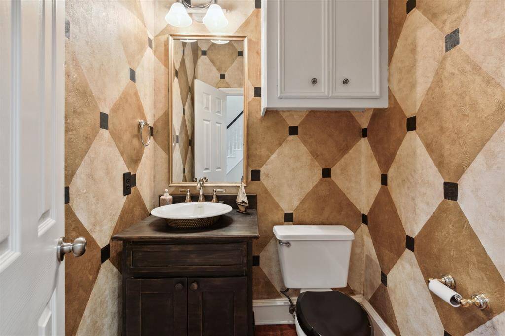 Stylish half bath with rich tones and modern vanity.