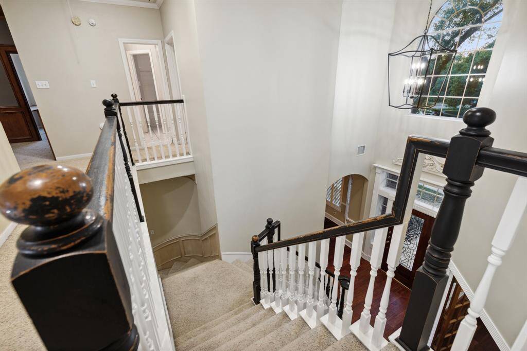 View of the grand staircase with soaring ceilings and upper hallway.