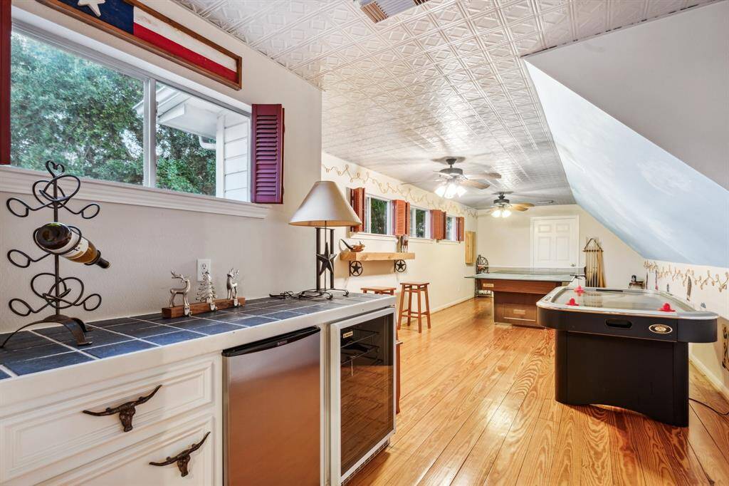 Charming wet bar with vintage vibes, built-in shelving, and wood floors.