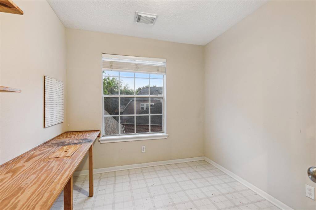 Functional space with built-in table and window—ideal for hobbies or laundry.