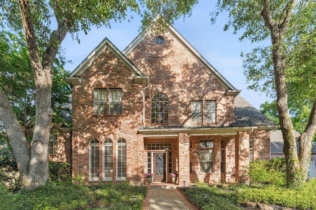 Stately exterior with a welcoming walkway and well-maintained front yard on a quiet cul-de-sac.