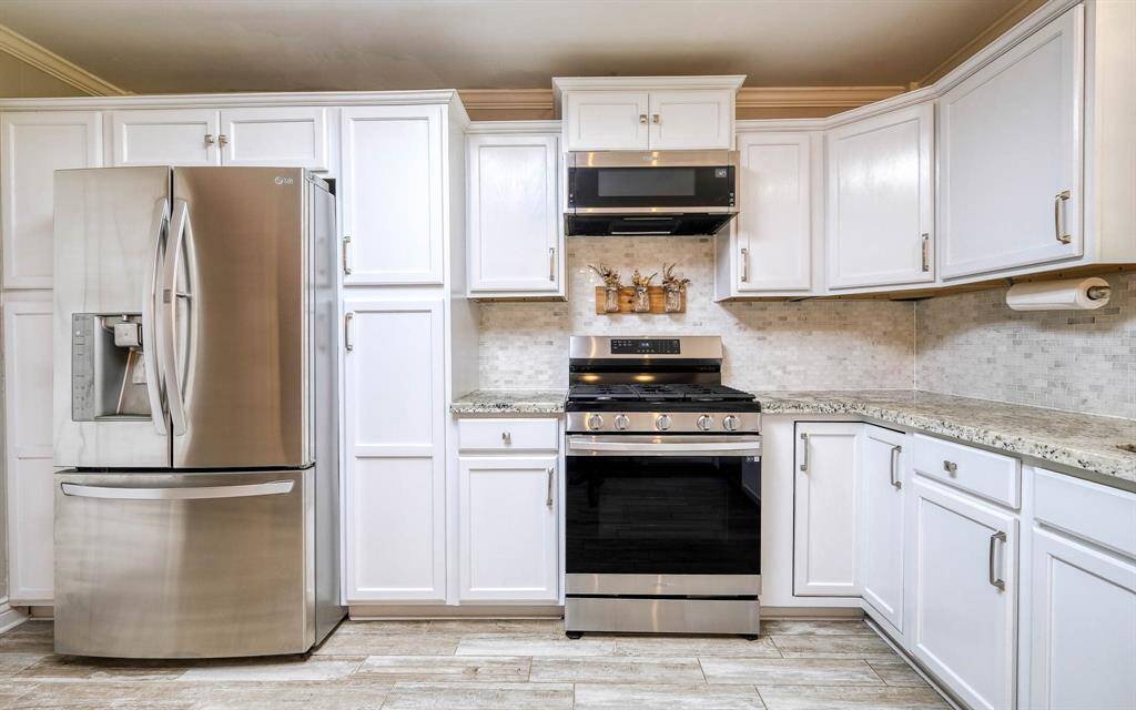 Kitchen with stainless appliances and granite countertops!
